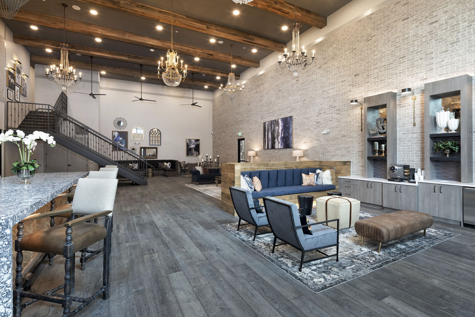 Clubhouse with contemporary design and lounge seating at Alta River Oaks Apartments