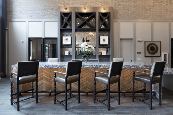 Clubhouse with modern design elements and cozy seating at Alta River Oaks Apartments, offering a luxurious community space for residents