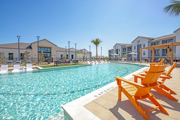 Scenic pool with lounge seating at Alta Rolling Oaks luxury apartments