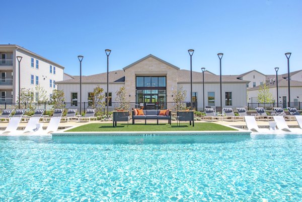 Resort-style pool with sun loungers at Alta Rolling Oaks luxury apartments