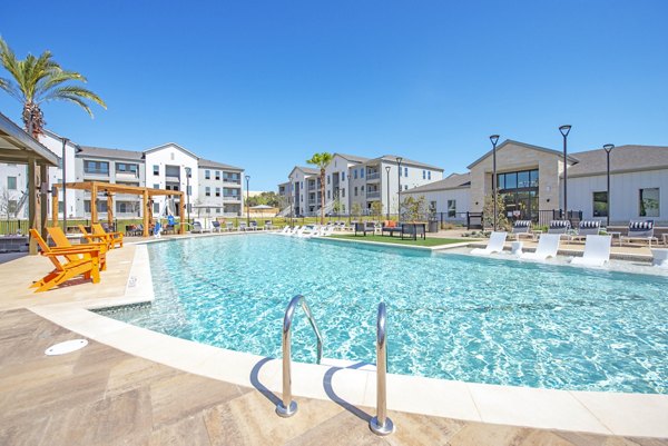 Resort-style swimming pool with sundeck at Alta Rolling Oaks apartments