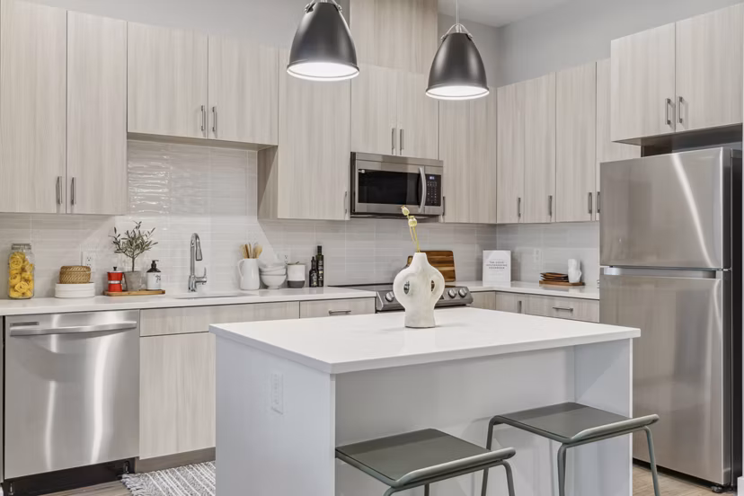 Modern kitchen with stainless steel appliances at Alta on the Row Apartments