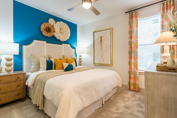 Spacious bedroom with modern furnishings in Alta Sergeant Apartments