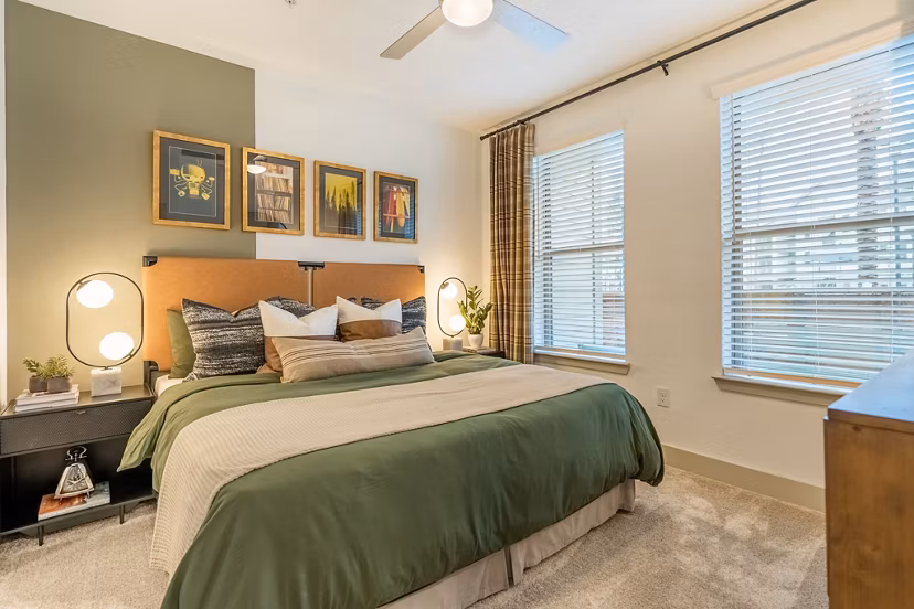 Cozy bedroom with modern furnishings at Alta Sergeant Apartments, offering luxury living spaces within the Greystar community