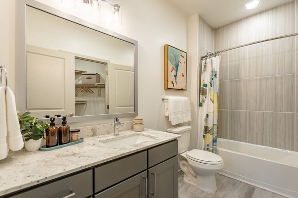 Contemporary bathroom with sleek fixtures and vanity in Alta Sergeant Apartments