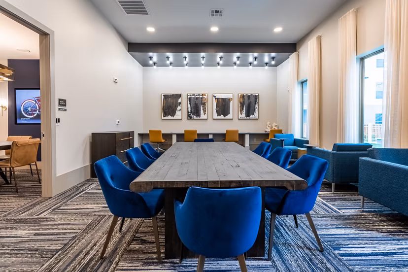 Modern clubhouse with lounge seating and billiards table at Alta Sergeant Apartments