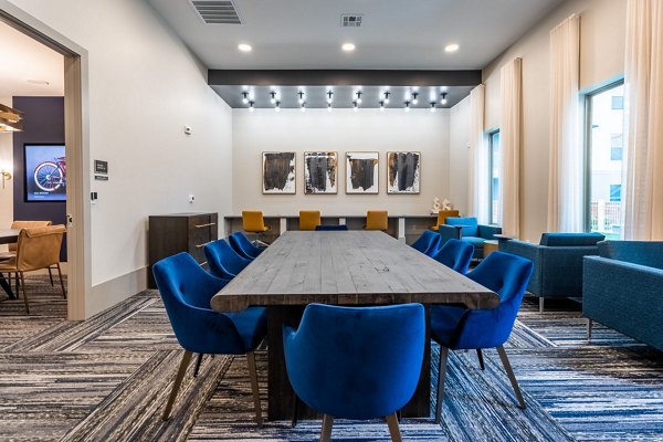 Modern clubhouse with lounge seating and billiards table at Alta Sergeant Apartments
