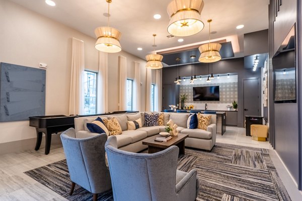 Clubhouse featuring modern furnishings and large communal spaces at Alta Sergeant Apartments