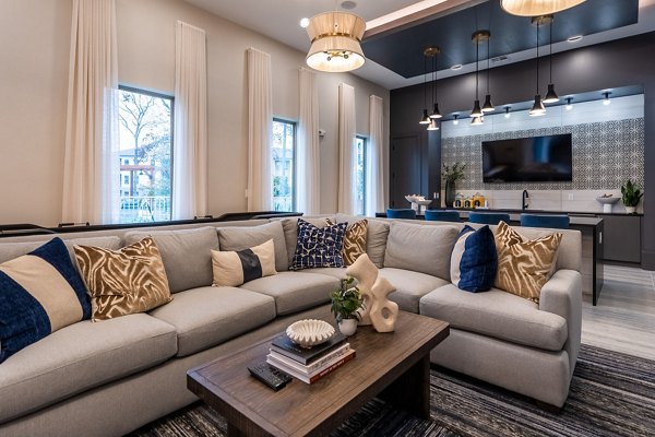 Chic clubhouse with modern seating and fireplace in Alta Sergeant Apartments