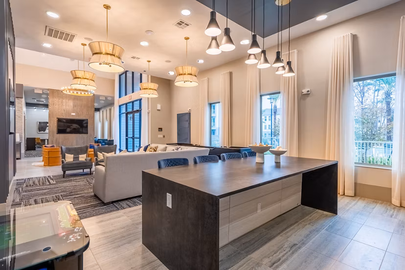 Clubhouse featuring modern design and seating areas at Alta Sergeant Apartments