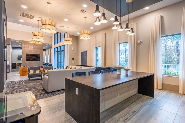 Clubhouse featuring modern design and seating areas at Alta Sergeant Apartments