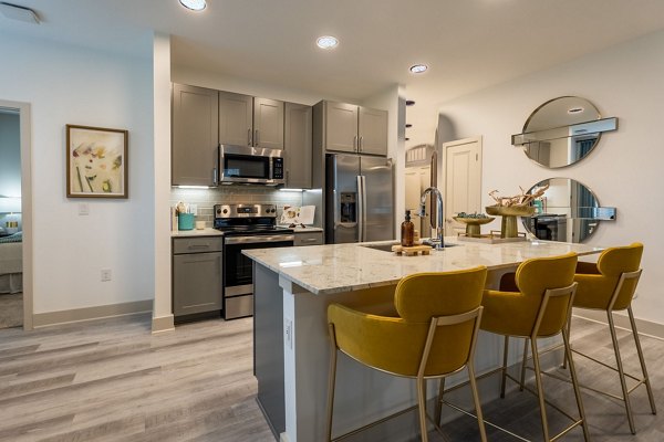 Modern kitchen with stainless steel appliances at Alta Sergeant Apartments