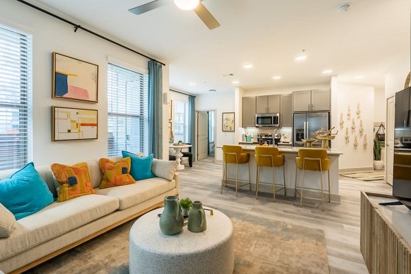 Spacious living room with modern furnishings at Alta Sergeant Apartments
