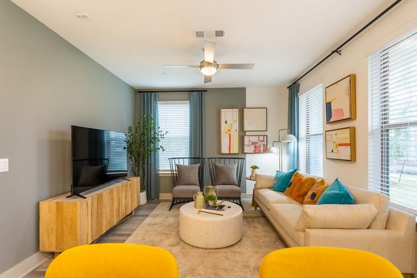 Spacious living room with modern decor at Alta Sergeant Apartments featuring luxury design elements