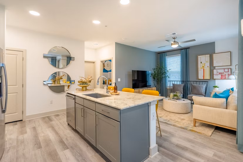 Spacious living room with modern dÃ©cor and large windows in Alta Sergeant Apartments Perfect for luxury living near city conveniences