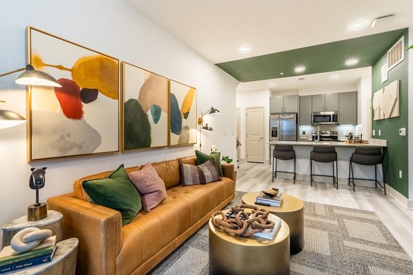 Spacious living room with modern decor in Alta Sergeant Apartments, luxury living by Greystar