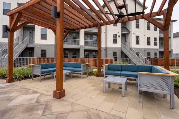 Patio with modern seating and lush landscaping at Alta Sergeant Apartments