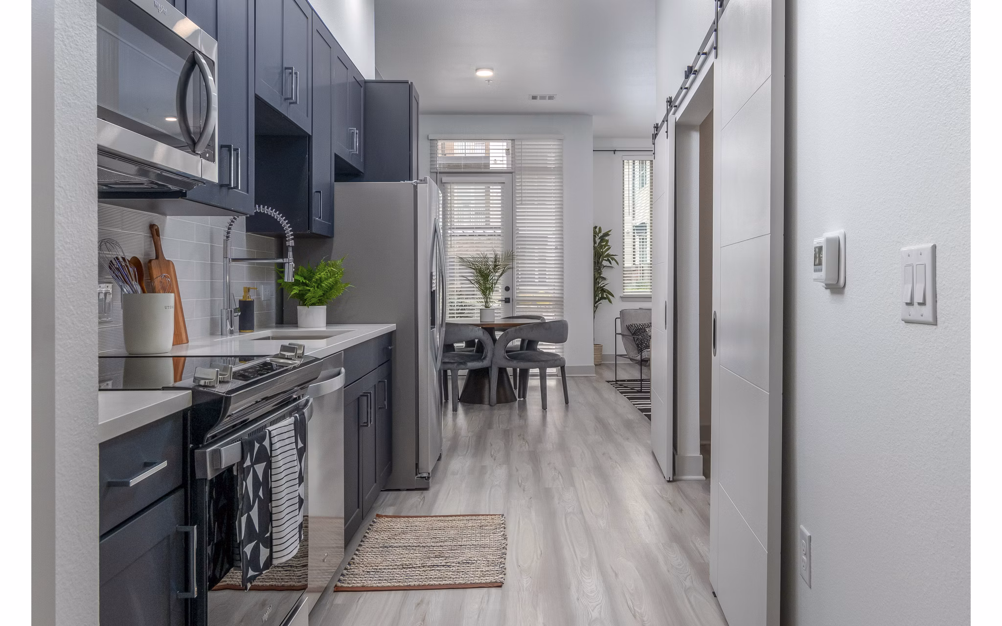 Modern kitchen with sleek appliances and granite countertops at Alta Sloan's Lake apartments