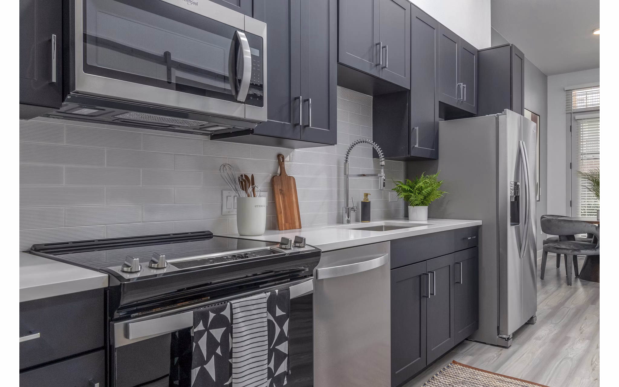 Modern kitchen featuring sleek cabinetry and stainless steel appliances in Alta Sloan's Lake luxury apartments
