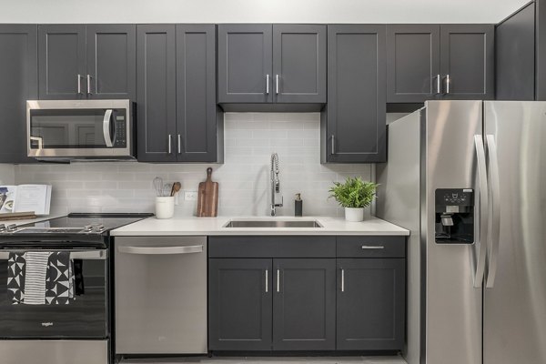 Modern kitchen with stainless steel appliances at Alta Sloan's Lake luxury apartments