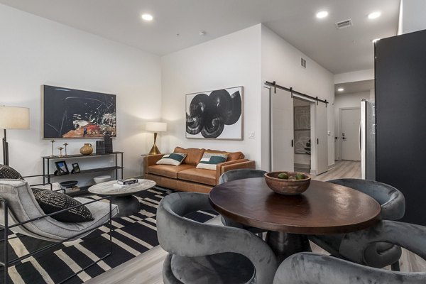 Modern living room with stylish decor and floor-to-ceiling windows at Alta Sloan's Lake apartments