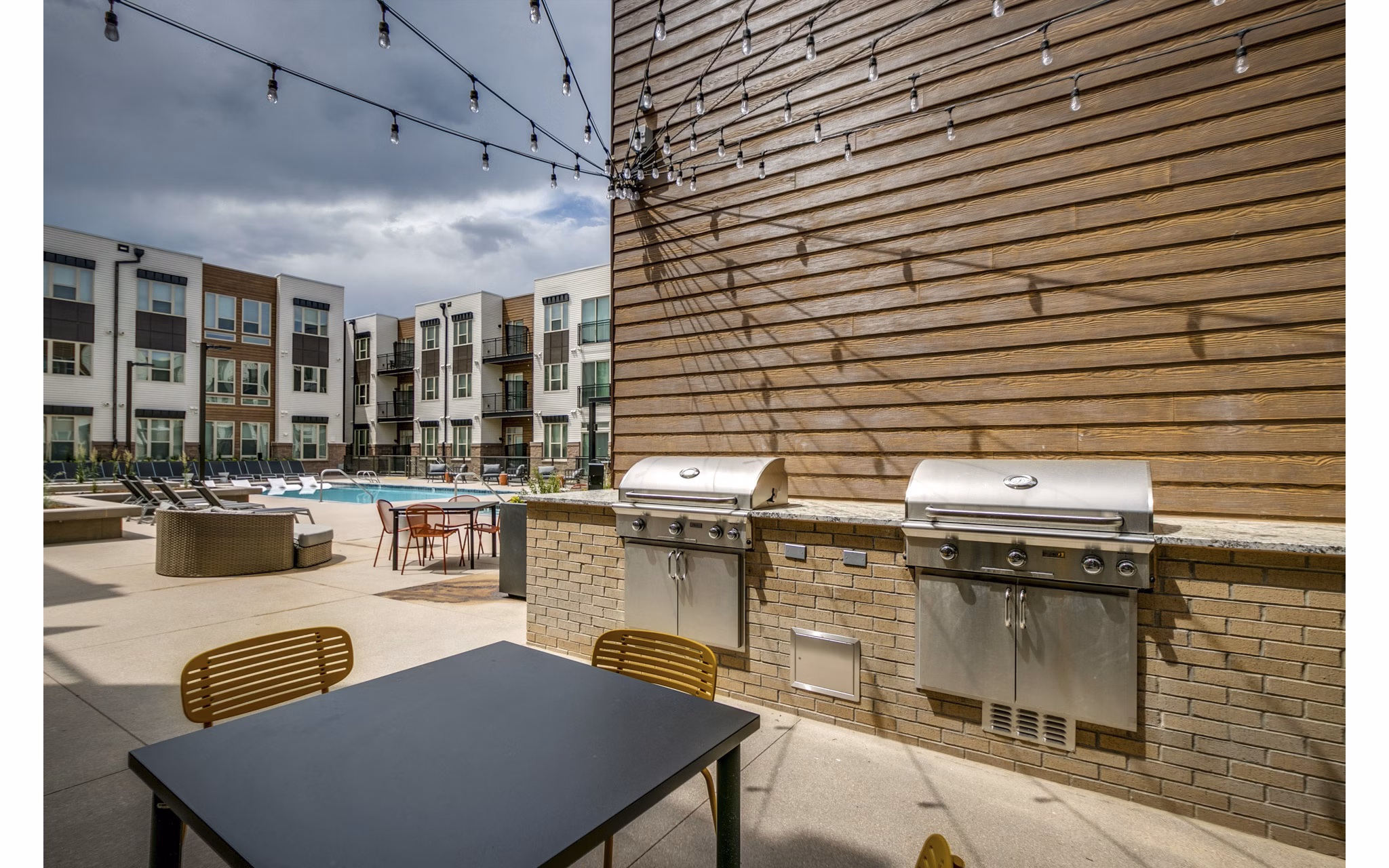 Resort-style pool with lounge chairs at Alta Sloan's Lake luxury apartments