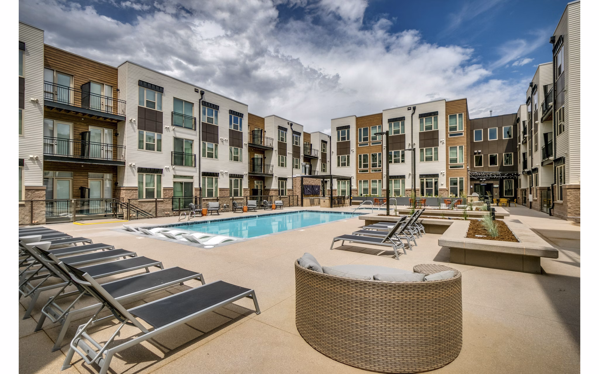 Outdoor pool area with lounge chairs at Alta Sloan's Lake luxury apartments, perfect for relaxation and leisure