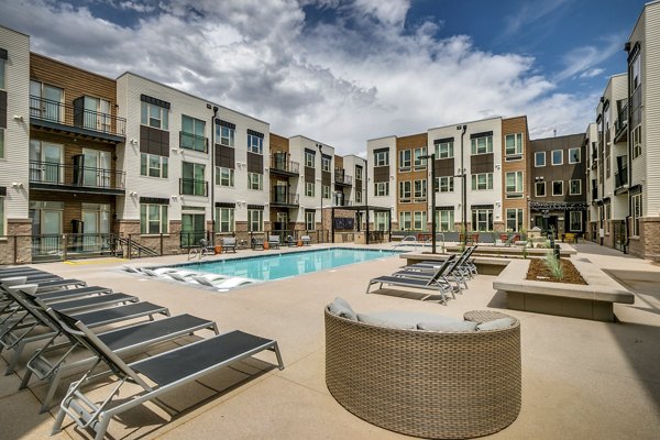 Outdoor pool area with lounge chairs at Alta Sloan's Lake luxury apartments, perfect for relaxation and leisure