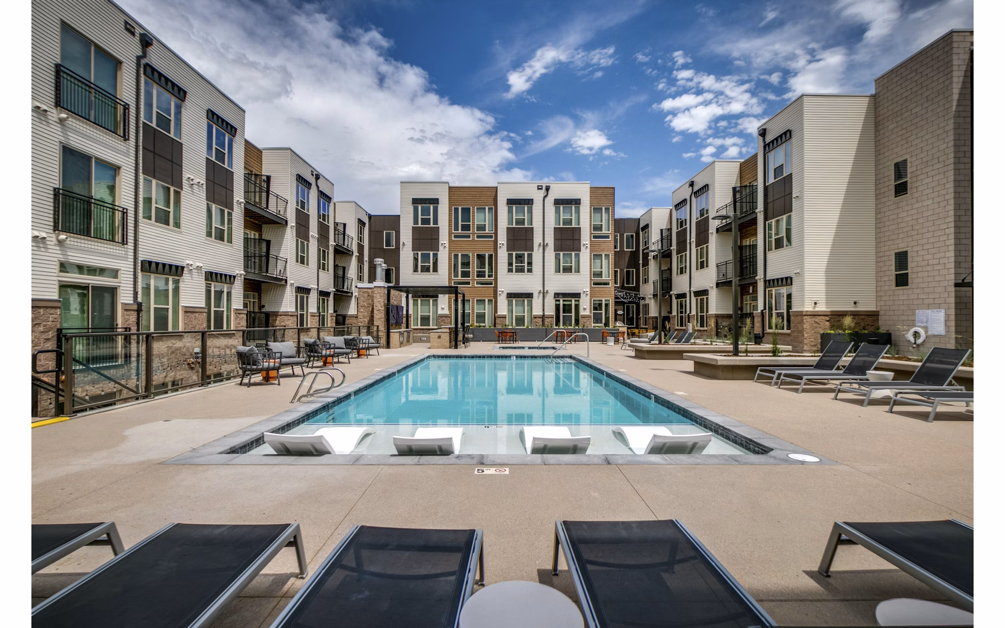 Relaxing poolside at Alta Sloan's Lake luxury apartments, perfect for unwinding and enjoying upscale amenities