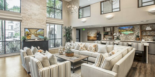 Clubhouse with modern design and comfortable seating at Alta South Bay Apartments