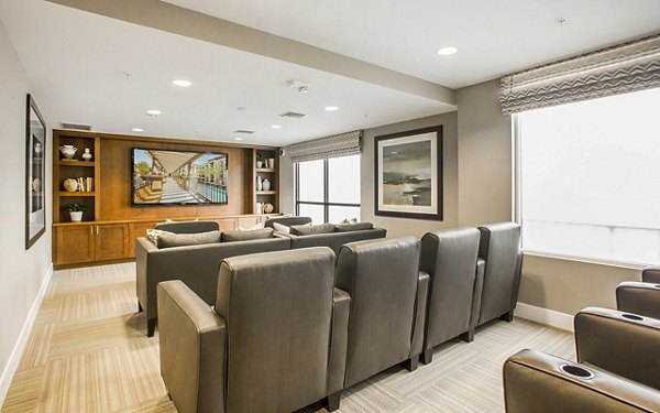 Modern clubhouse theater with plush seating at Alta South Bay Apartments, ideal for movie nights and social gatherings