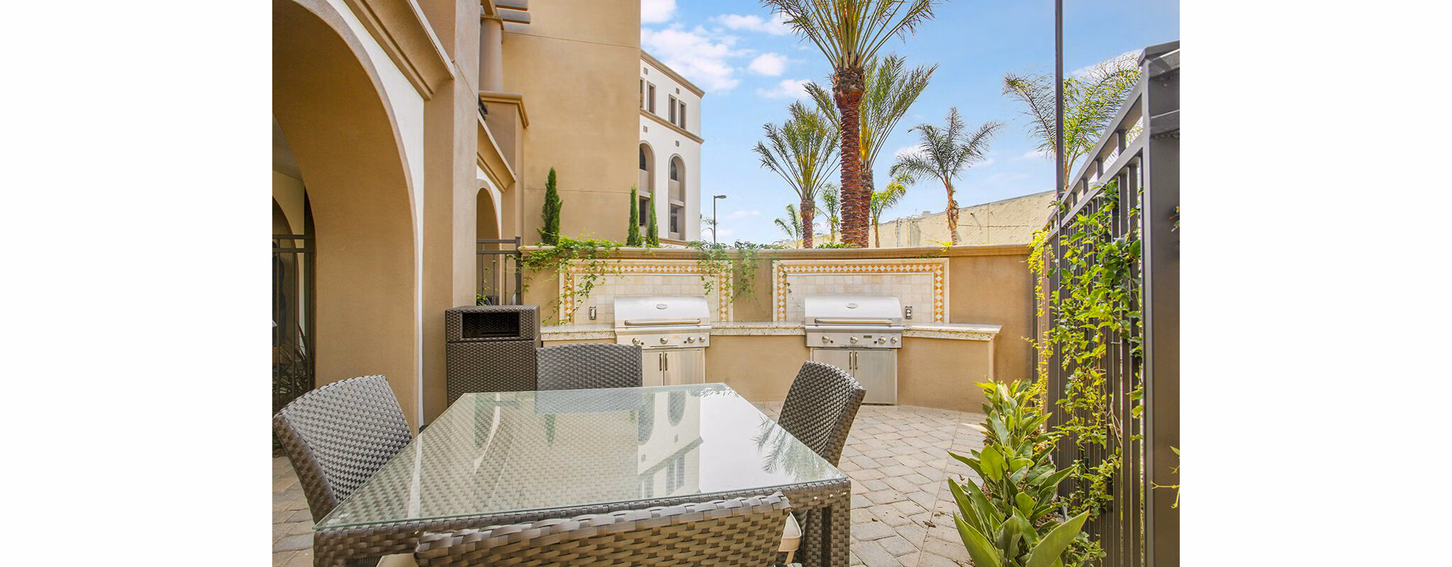 Grill area with modern patio furniture at Alta South Bay Apartments