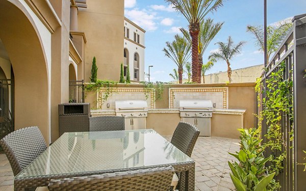 Grill area with modern patio furniture at Alta South Bay Apartments