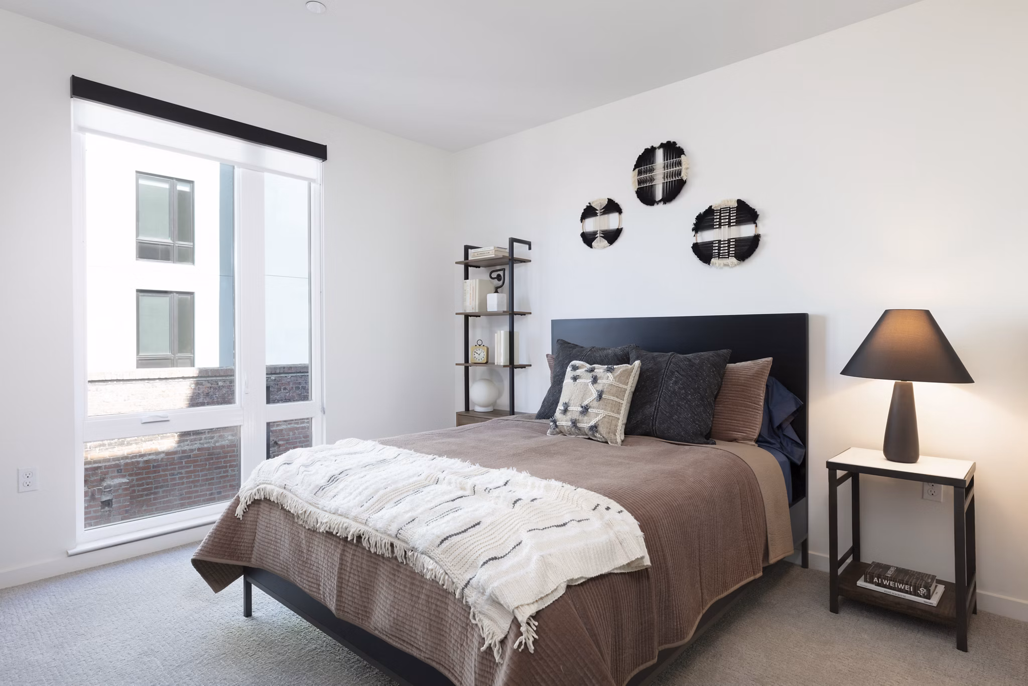 Cozy bedroom with modern decor and large windows at Alta Star Harbor Apartments, a luxury living community