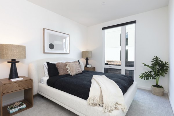 Cozy bedroom with modern decor and ample natural light at Alta Star Harbor Apartments
