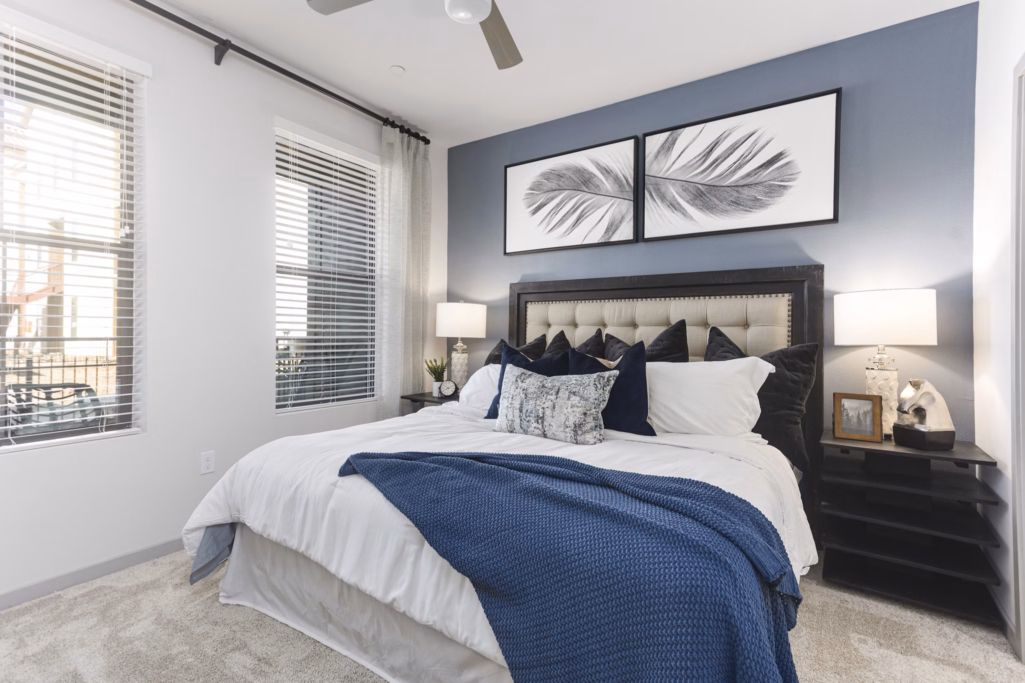 Elegant bedroom at Alta Surprise Apartments with modern decor and plush bedding, offering luxury living experience in vibrant surroundings