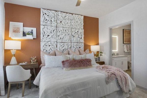 Bedroom with modern furnishings and natural light at Alta Surprise Apartments