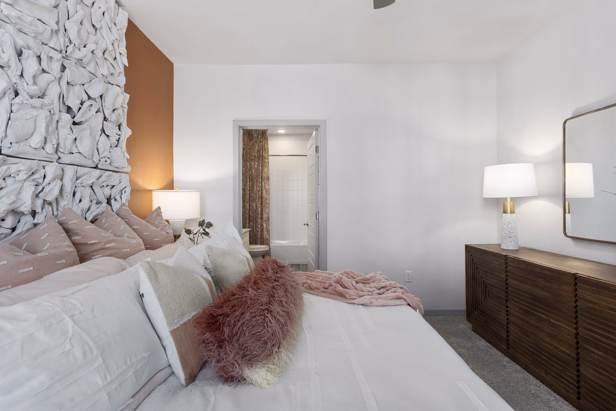 Elegant bedroom with modern furnishings and large windows in Alta Surprise Apartments