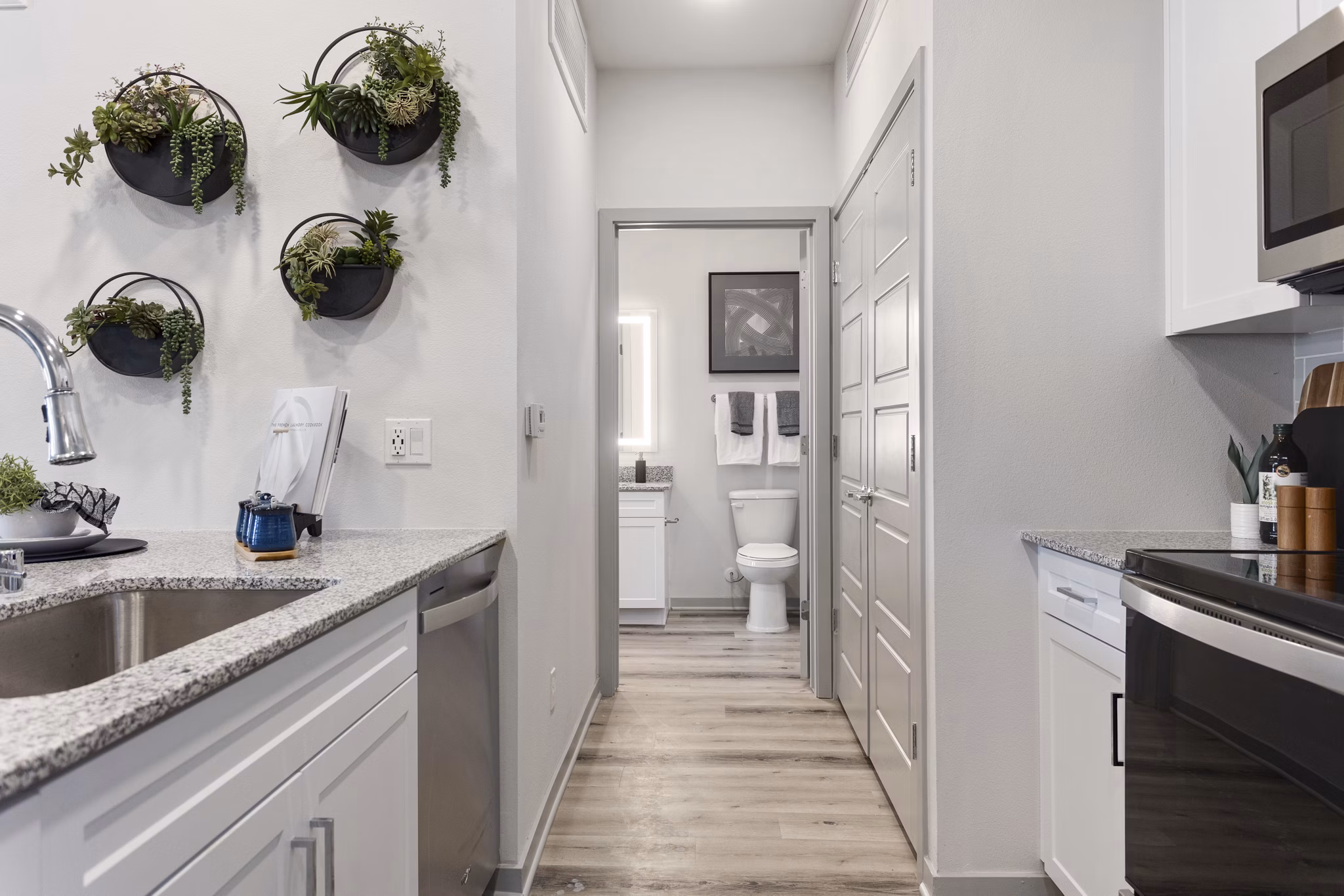 Modern bathroom featuring sleek countertops and glass shower in Alta Surprise Apartments