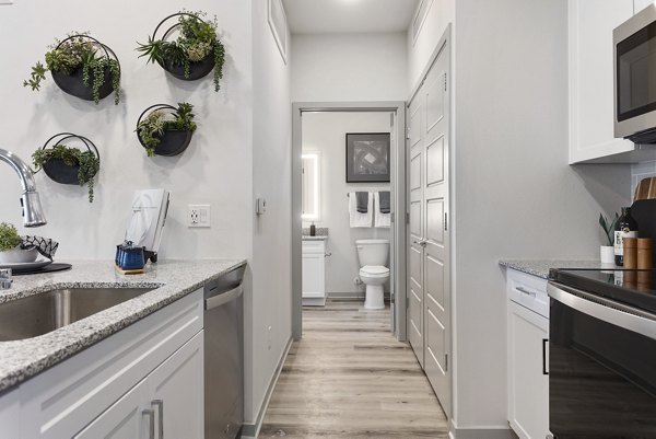 Modern bathroom featuring sleek countertops and glass shower in Alta Surprise Apartments