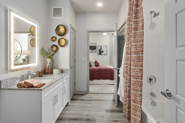 Luxurious bathroom with modern fixtures at Alta Surprise Apartments