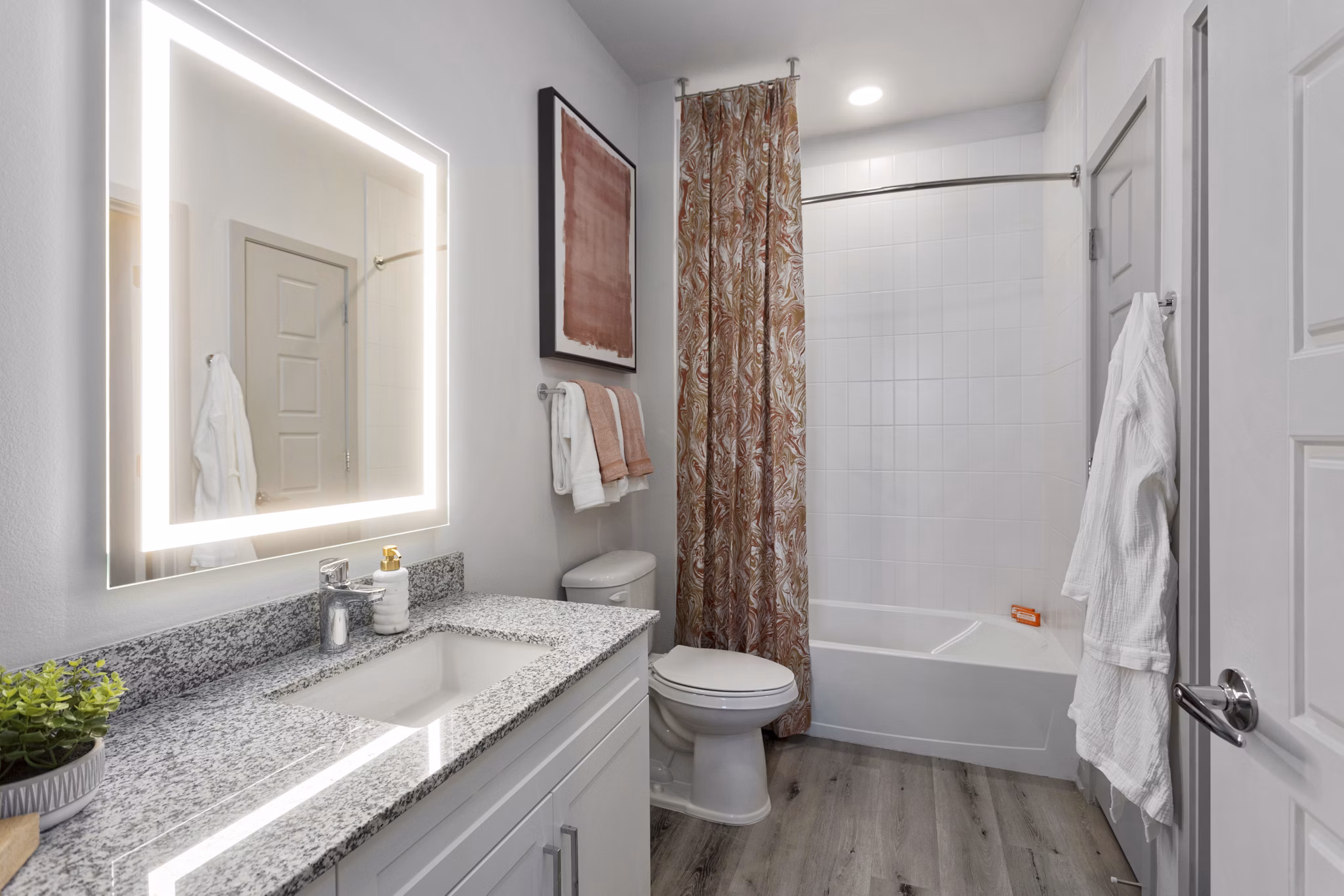 Luxurious bathroom with modern fixtures at Alta Surprise Apartments