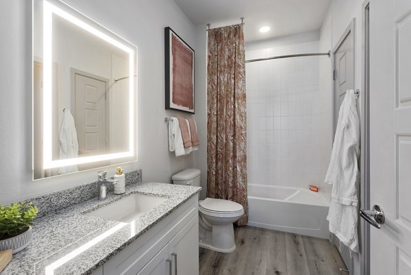 Luxurious bathroom with modern fixtures at Alta Surprise Apartments
