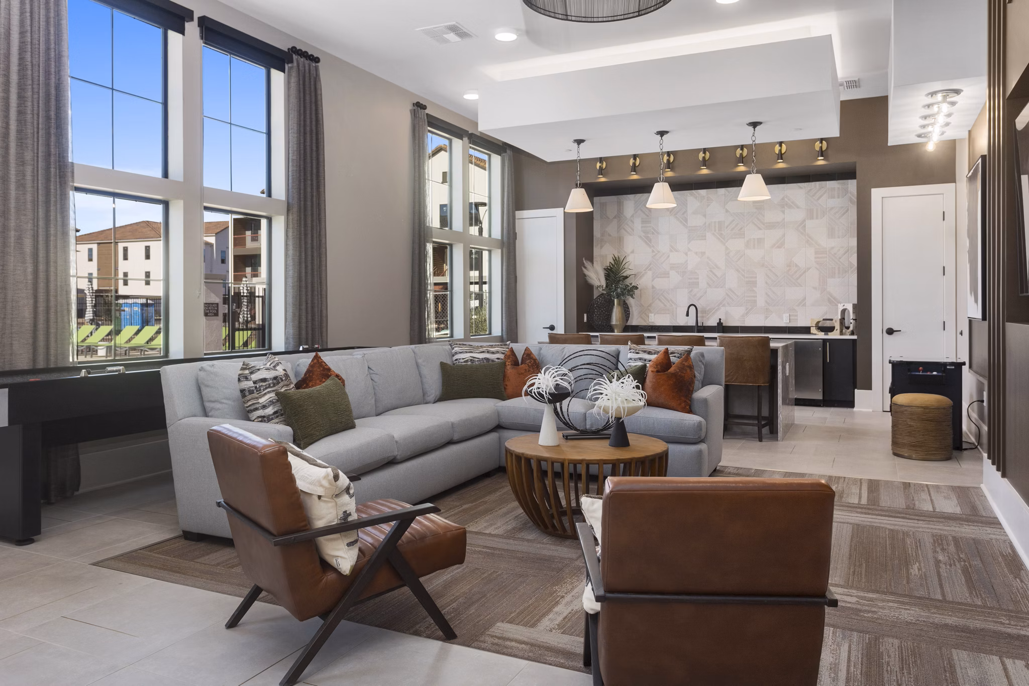 Modern clubhouse with stylish seating and open spaces at Alta Surprise Apartments, ideal for gatherings and relaxation