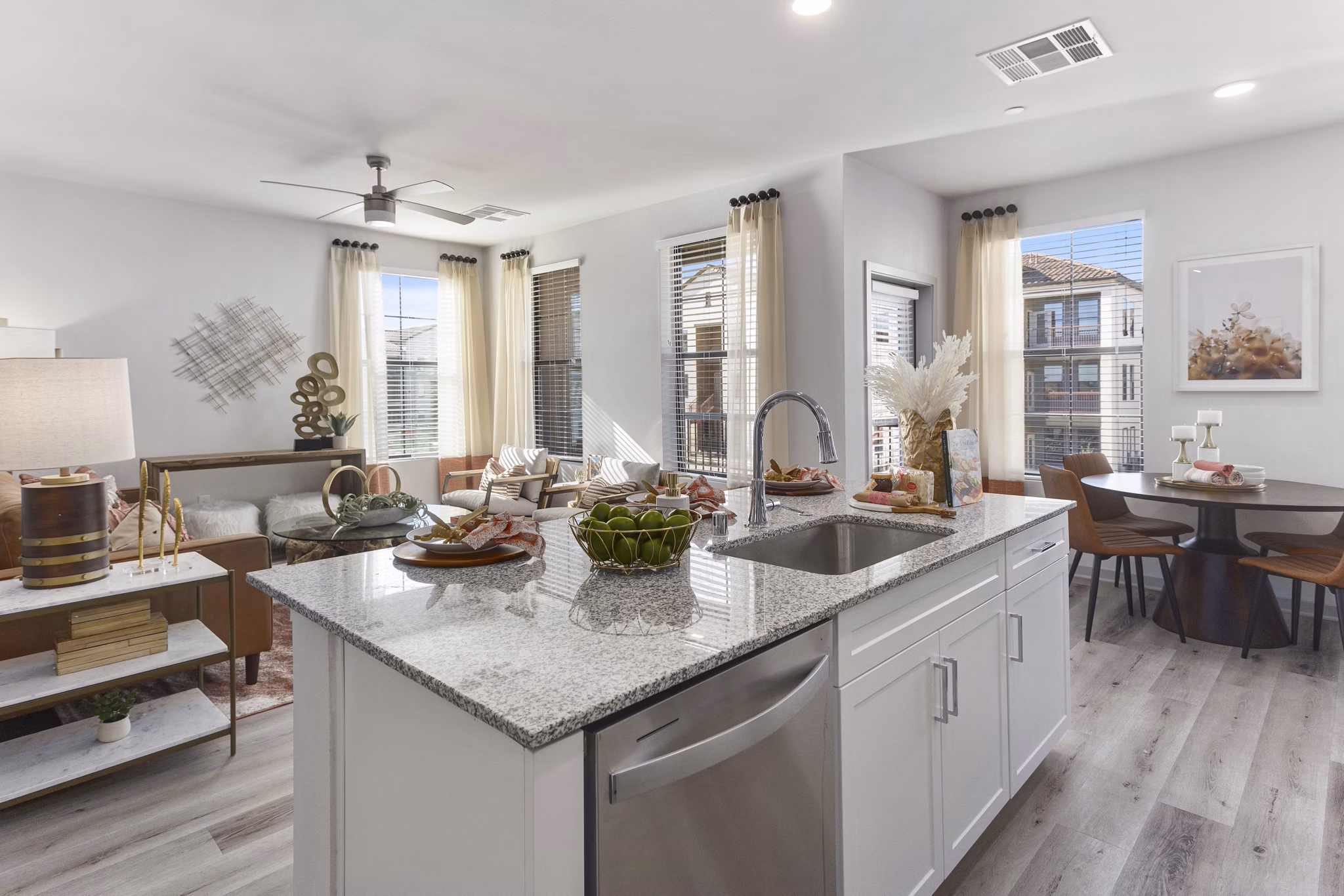 Modern kitchen with stainless steel appliances and quartz countertops in Alta Surprise Apartments luxury living