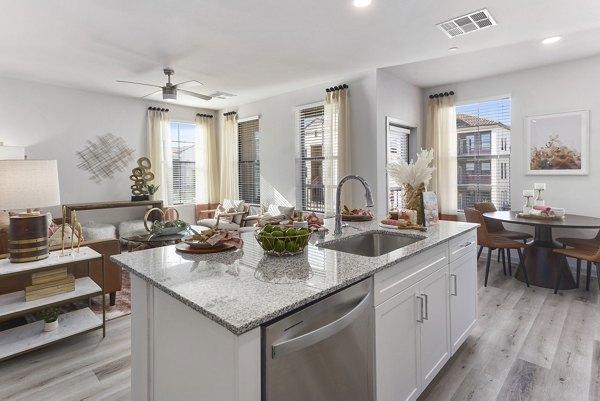 Modern kitchen with stainless steel appliances and quartz countertops in Alta Surprise Apartments luxury living