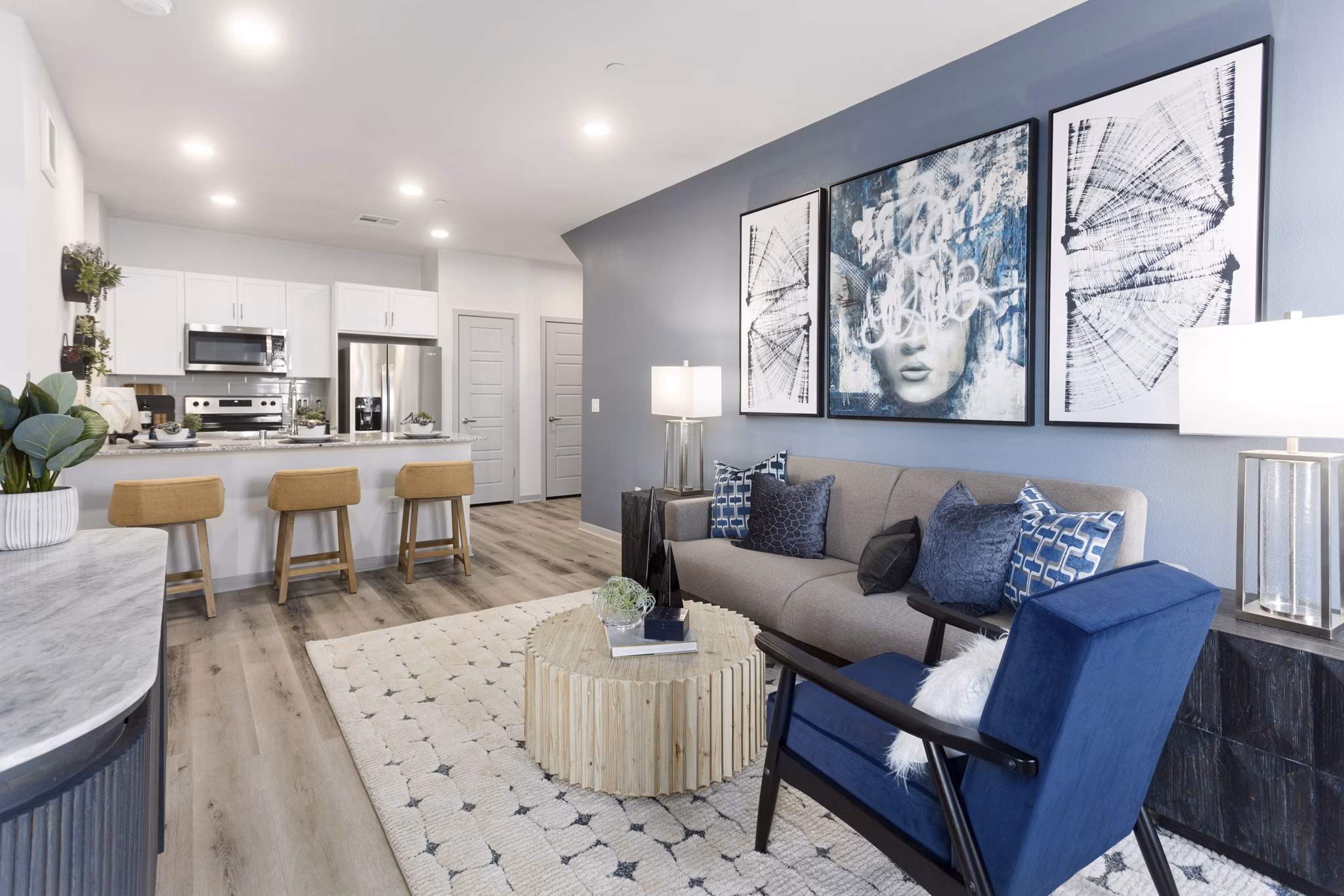 Spacious living room with modern decor and natural light in Alta Surprise Apartments
