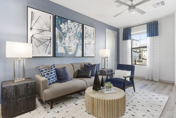 Modern living room with stylish decor and natural light at Alta Surprise Apartments, a Greystar luxury apartment community
