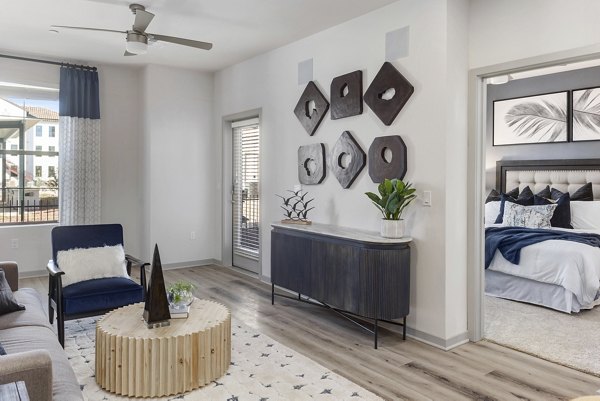Spacious living room with modern decor and natural light at Alta Surprise Apartments