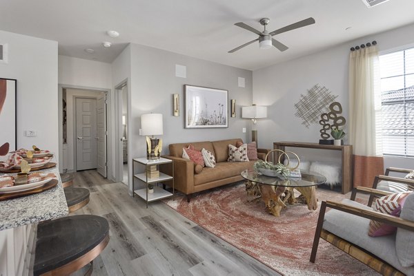 Spacious living room with modern decor at Alta Surprise Apartments